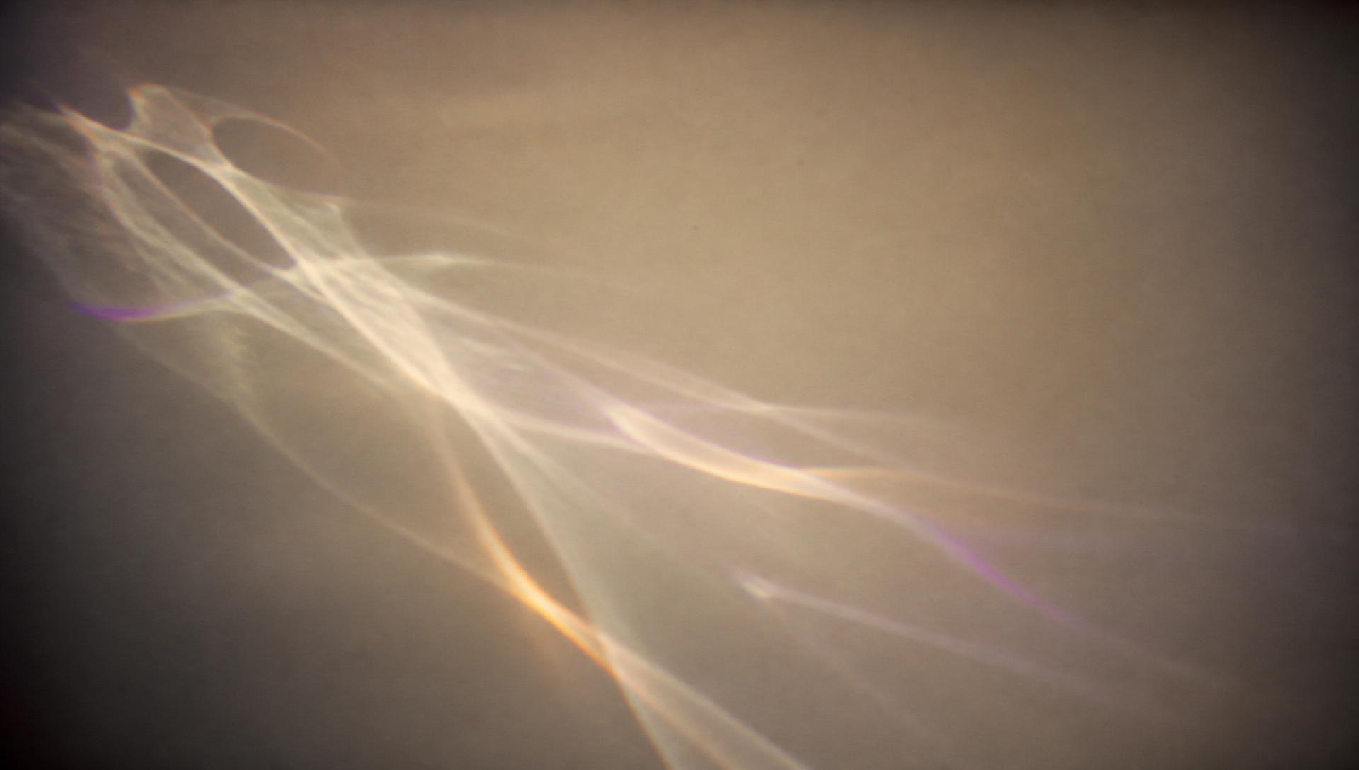 Soft prism light refracting across an ivory surface